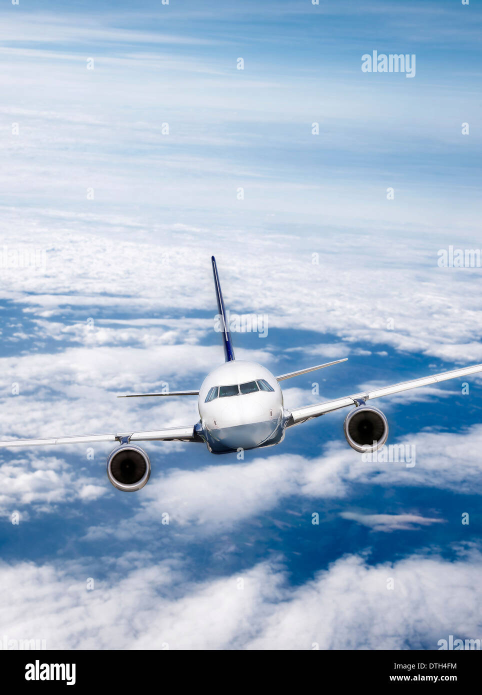 Airliner in flight against a cloudy sky. Stock Photo