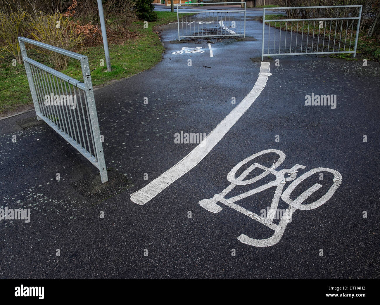 A confusing cycle path junction with metal gates blocking the path and causing a blockage to direction of travel. Stock Photo