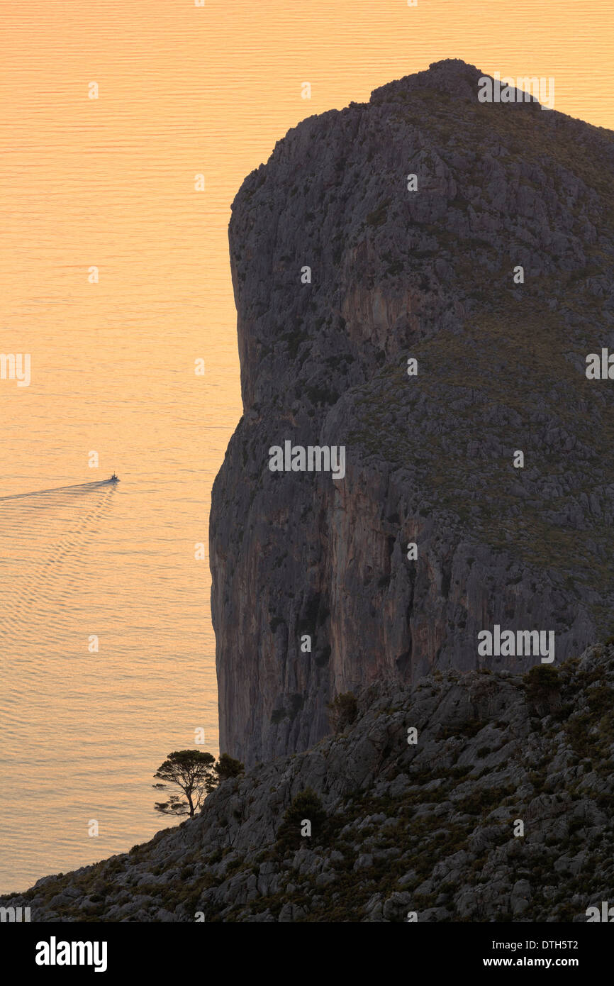 Majorca's north coast. Morro de sa Vaca silhouette and fishing boat at sunrise. Torrent de Pareis area. Balearic islands, Spain Stock Photo