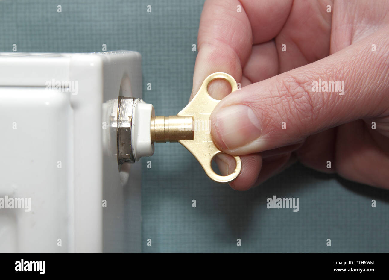 Man bleeding domestic radiator at home, England, UK Stock Photo