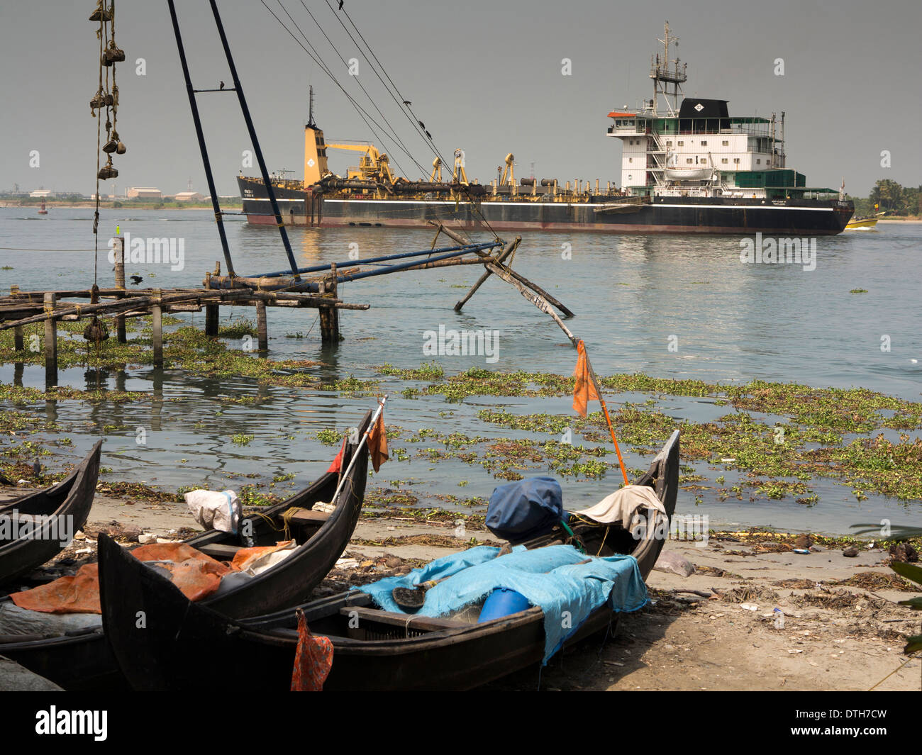 India, Kerala, Fort Cochin Port, Bulk Carrier ship passing Chinese Fishing Nets Stock Photo