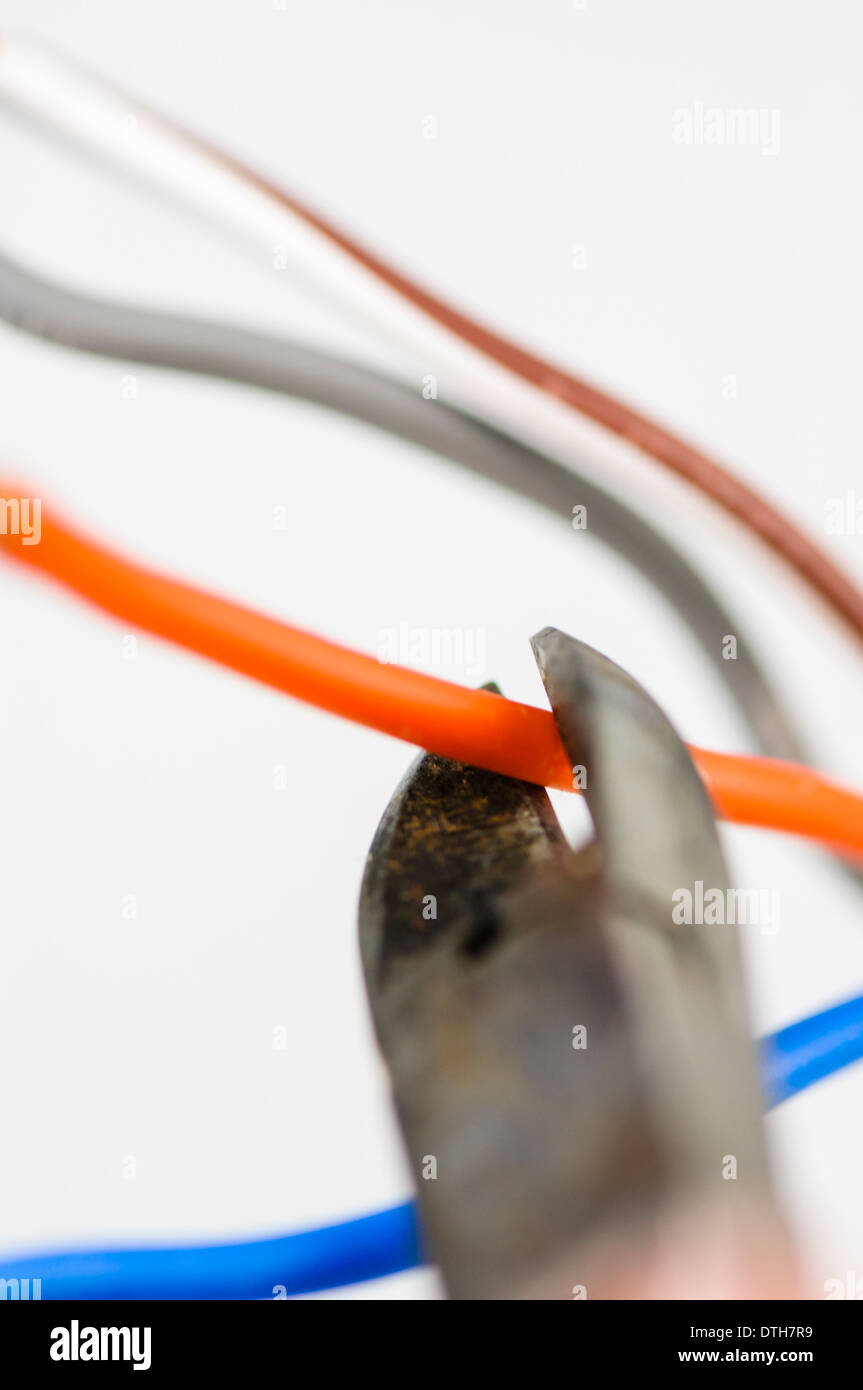 Using wire-cutters to cut a wire Stock Photo