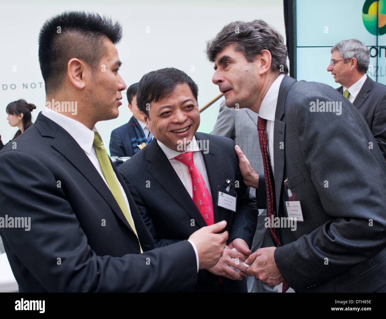 (L-R) Vice President of Chin Group Chuan Lu, Chint Group Manager Cunhui Nan and mayor Martin Wilke (non-party) talk to each other at the opening of the solar plant of the Astronergy Solarmodule GmbH company in Frankfurt Oder, Germany, 18 February 2014. The new Chinese owner presented his plans for the plant on the same day. The Astronergy Solarmodule GmbH took over the module factory of insolvent solar company Conergy in early 2014. About 200 jobs are supposed to be saved at the location. Astronergy is part of the worldwide operating Chint Group. Photo: Patrick Pleul/ZB Stock Photo