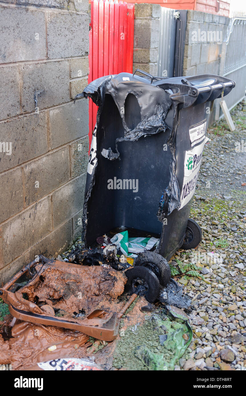 Two plastic bins melted after being set on fire. Stock Photo