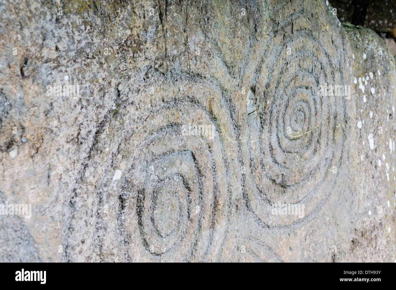Spiral carvings on one of the kerb stones at Newgrange chambered passage tomb Stock Photo