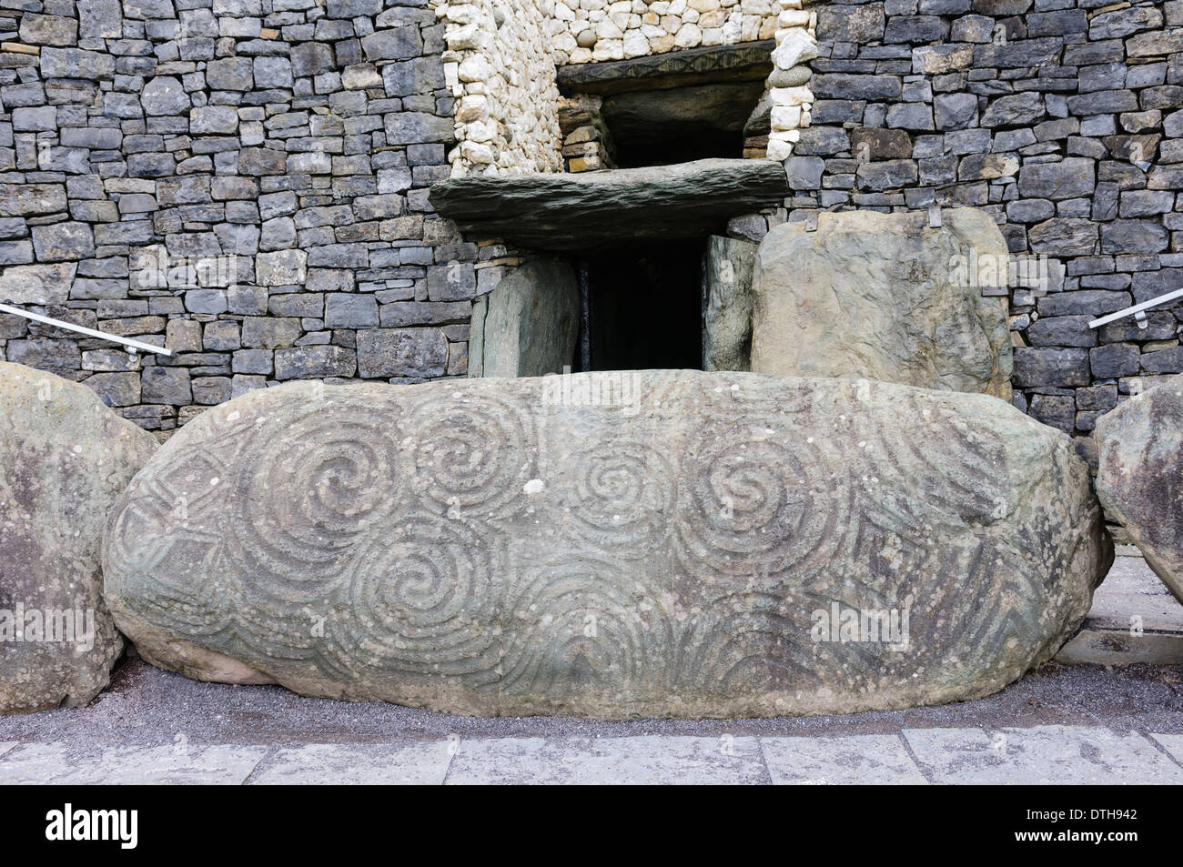 Spiral carvings on a kerb stone at the entrance to Newgrange chambered passage tomb Stock Photo