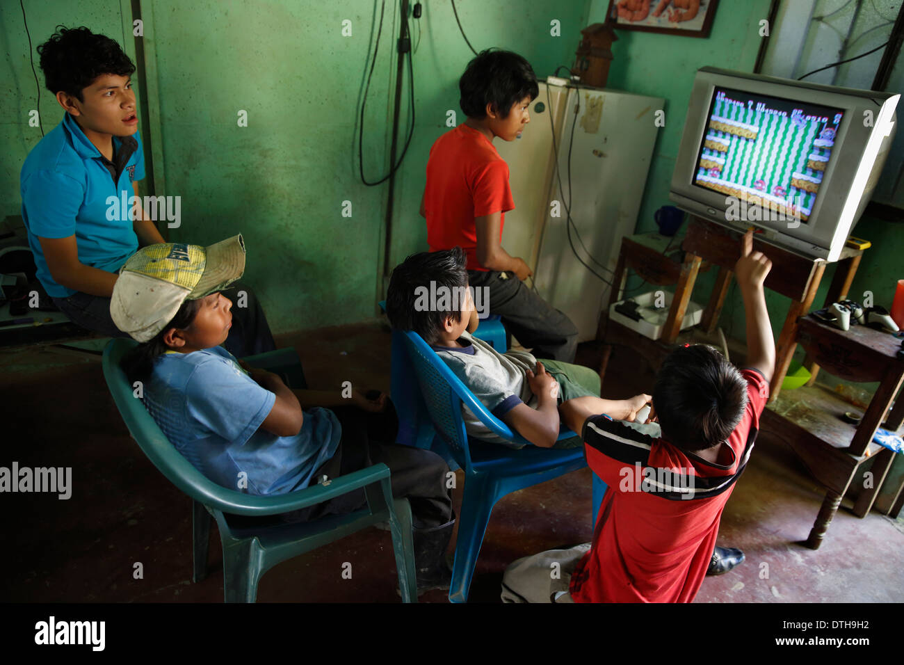 Boys playing video game, San Ramon, Nicaragua Stock Photo