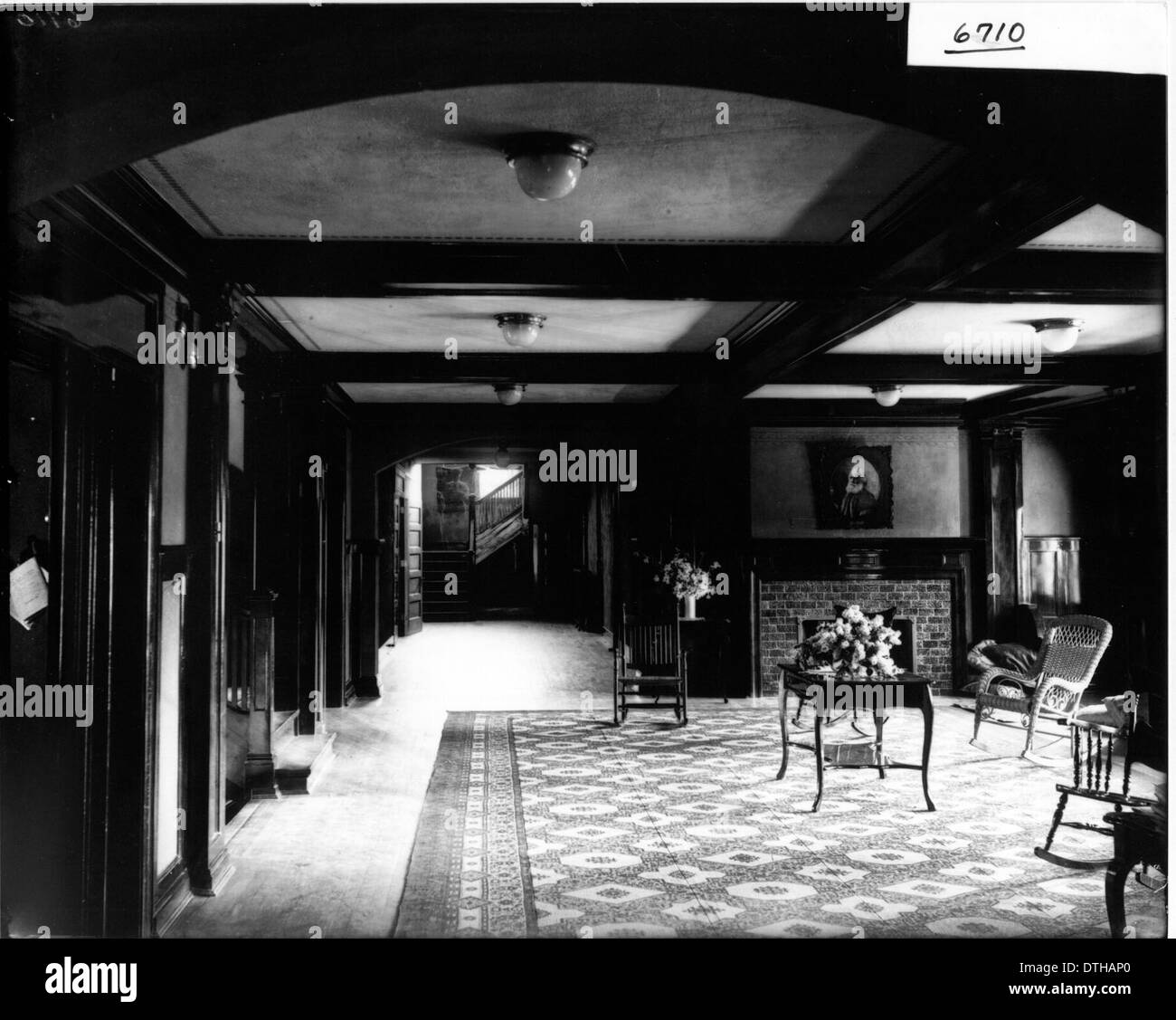 View of hallway, chairs, table and fireplace, Hepburn Hall 1905 Stock