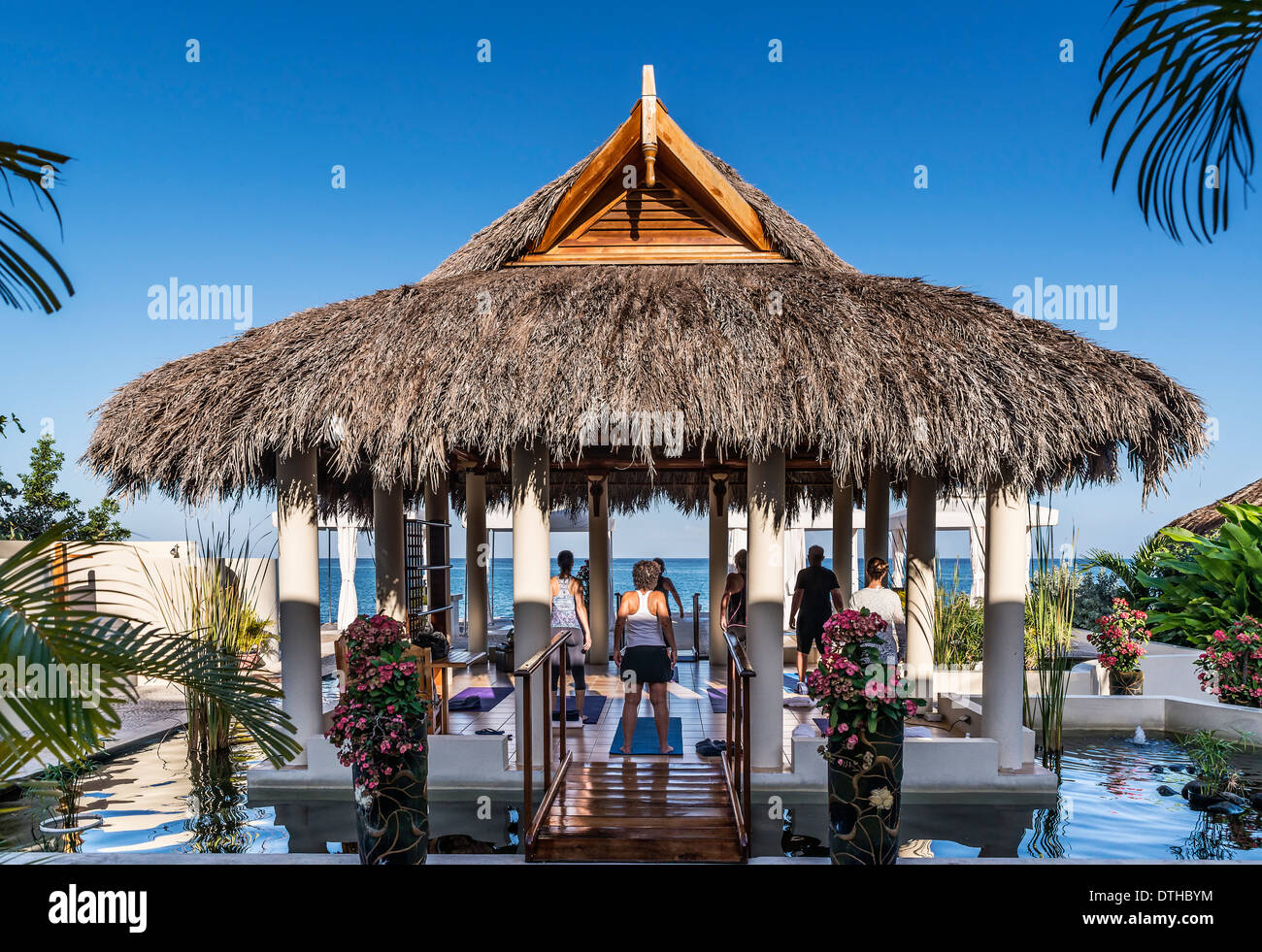 Waterfront instruction at a yoga retreat, Negril, Jamaica Stock Photo