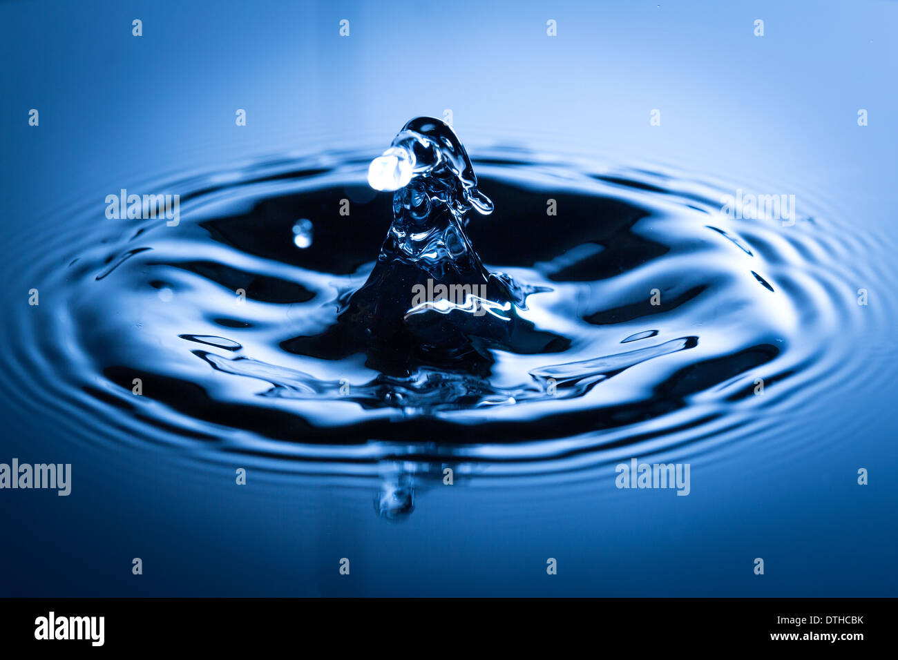 Water drop in sunlight. Blue tone image Stock Photo