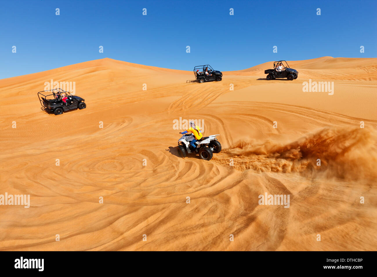 Quad driving in Dubai desert Stock Photo