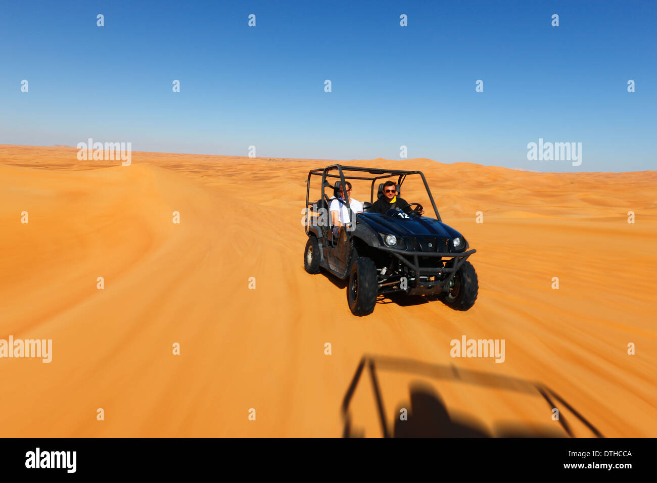 Quad driving in Dubai desert Stock Photo
