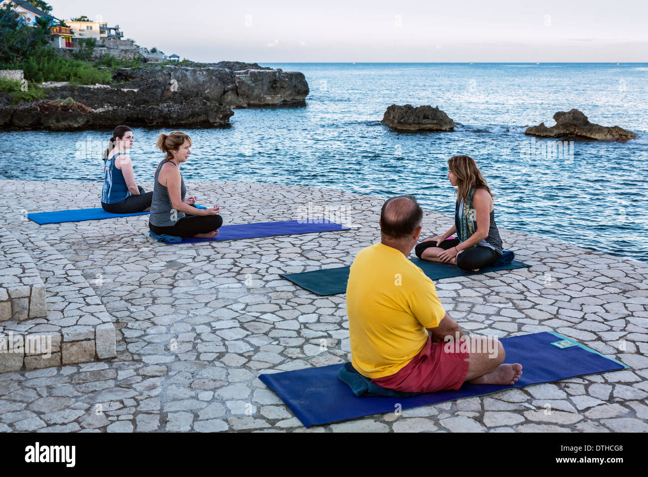 Waterfront instuction at a yoga retreat, Negril, Jamaica Stock Photo