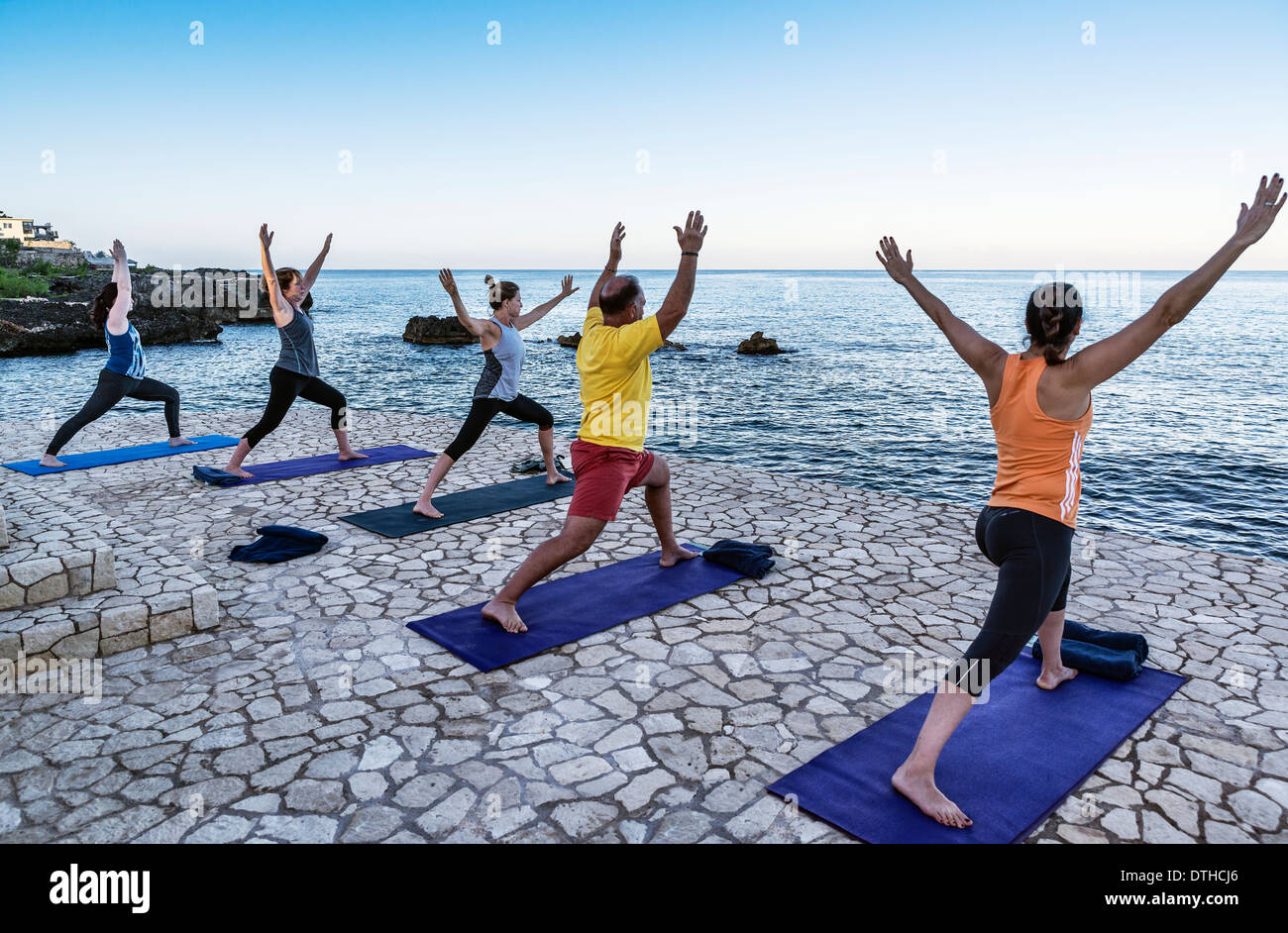 Waterfront instruction at a yoga retreat, Negril, Jamaica Stock Photo