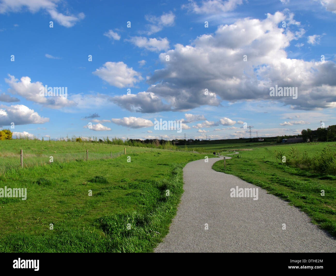 a landscape view a footpath with blue sky and white clouds in the ...
