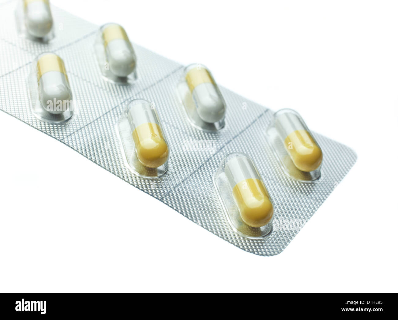 Yellow and white Tamiflu capsules in a blister pack on a white background Stock Photo
