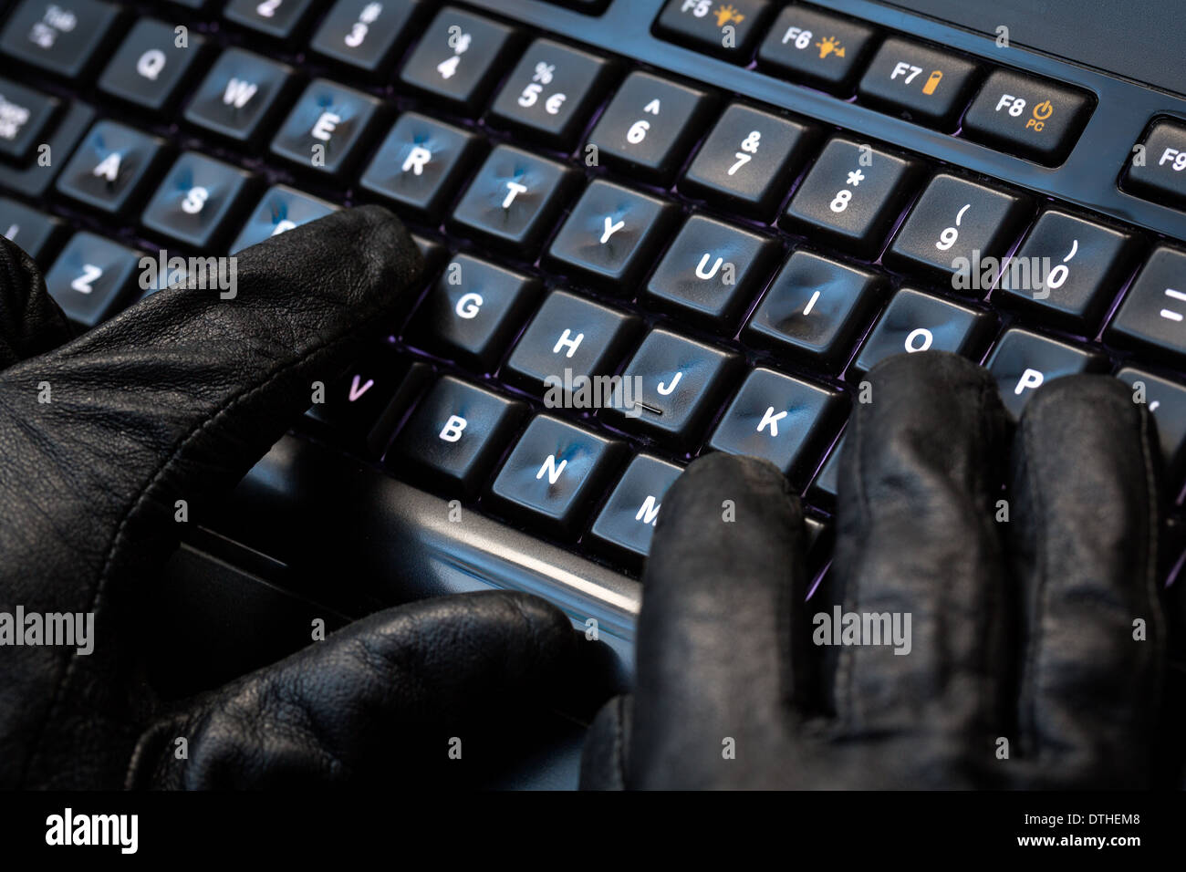 Hacker using laptop. Lots of digits on the computer screen. Stock Photo