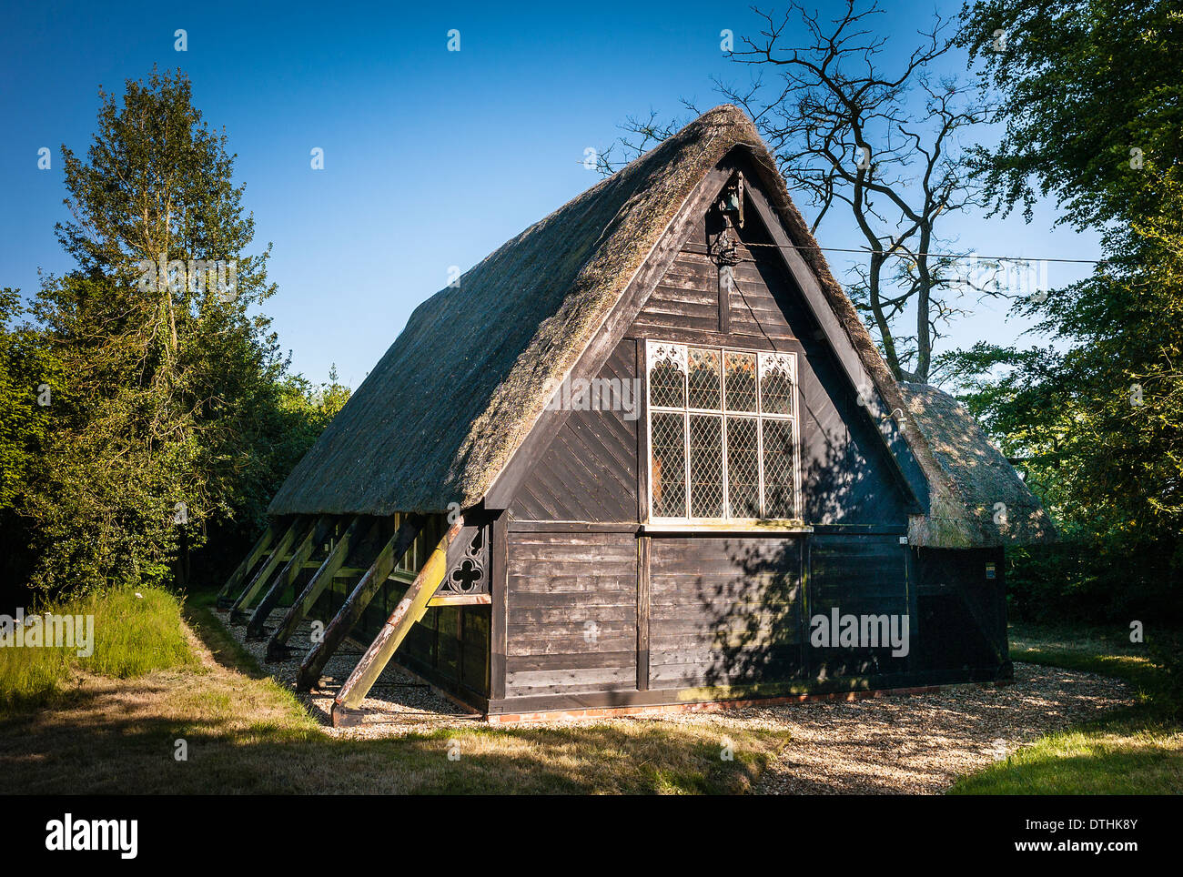 Old Victorian thatched wooden church in small village of Sandy Lane UK Stock Photo