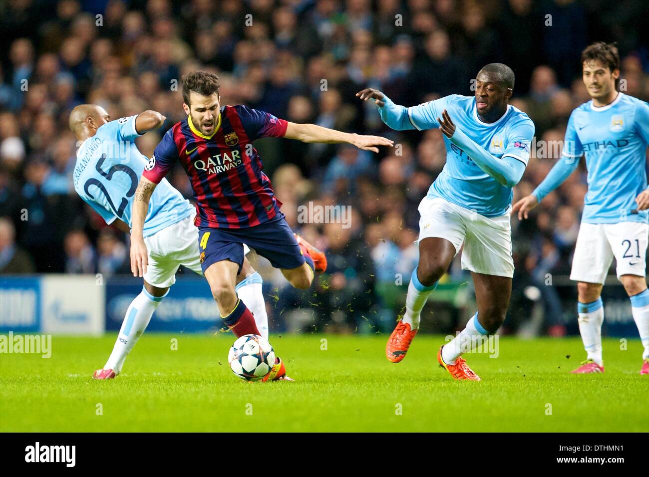 Manchester, UK. 18th Feb, 2014. FC Barcelona midfielder Cesc F&#xe0;bregas skips between Manchester City midfielders Toure and Fernandinho during the Champions League game between Manchester City and Barcelona from the Etihad Stadium. Credit:  Action Plus Sports/Alamy Live News Stock Photo