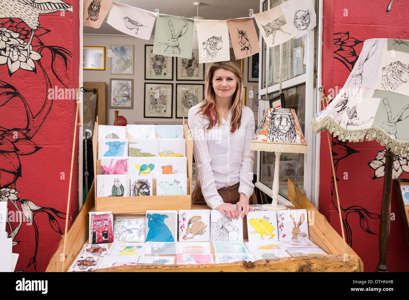 Illustrator designer with pop up shop out of her front window in