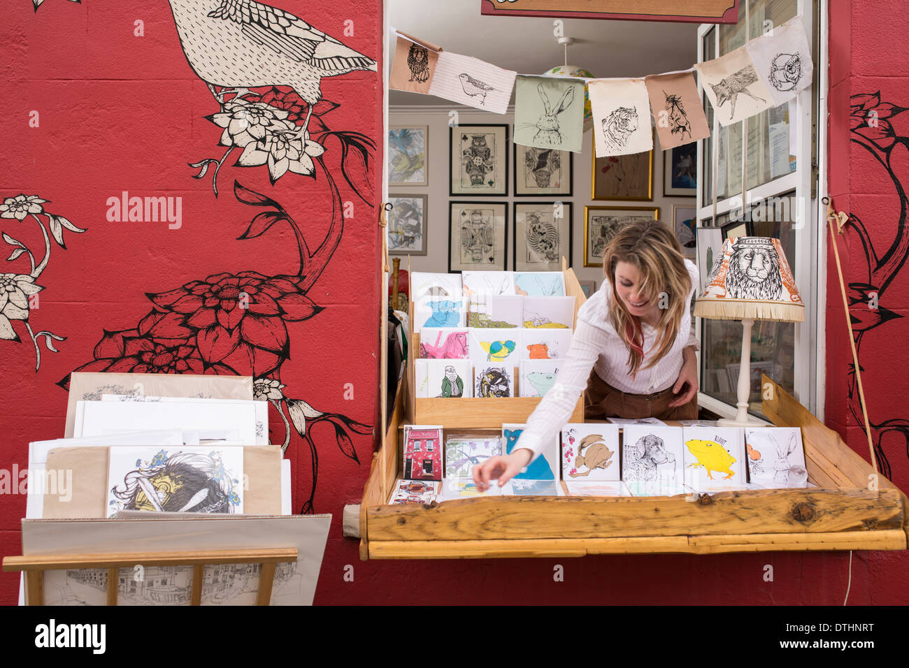 Illustrator designer with pop up shop out of her front window in