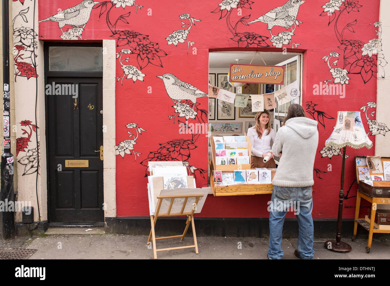 Illustrator designer with pop up shop out of her front window in