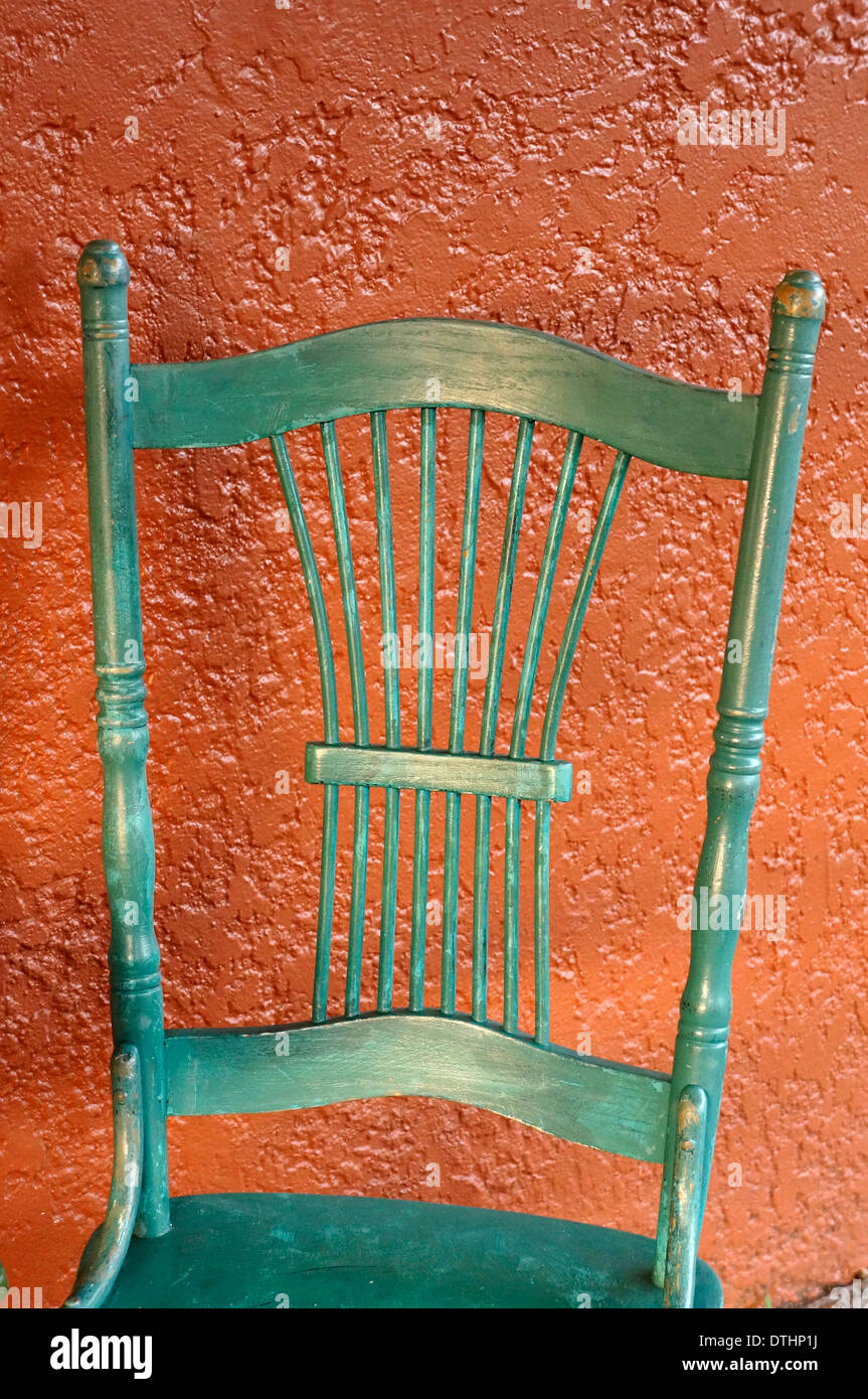 Old fashioned green chair and adobe colored wall Stock Photo Alamy