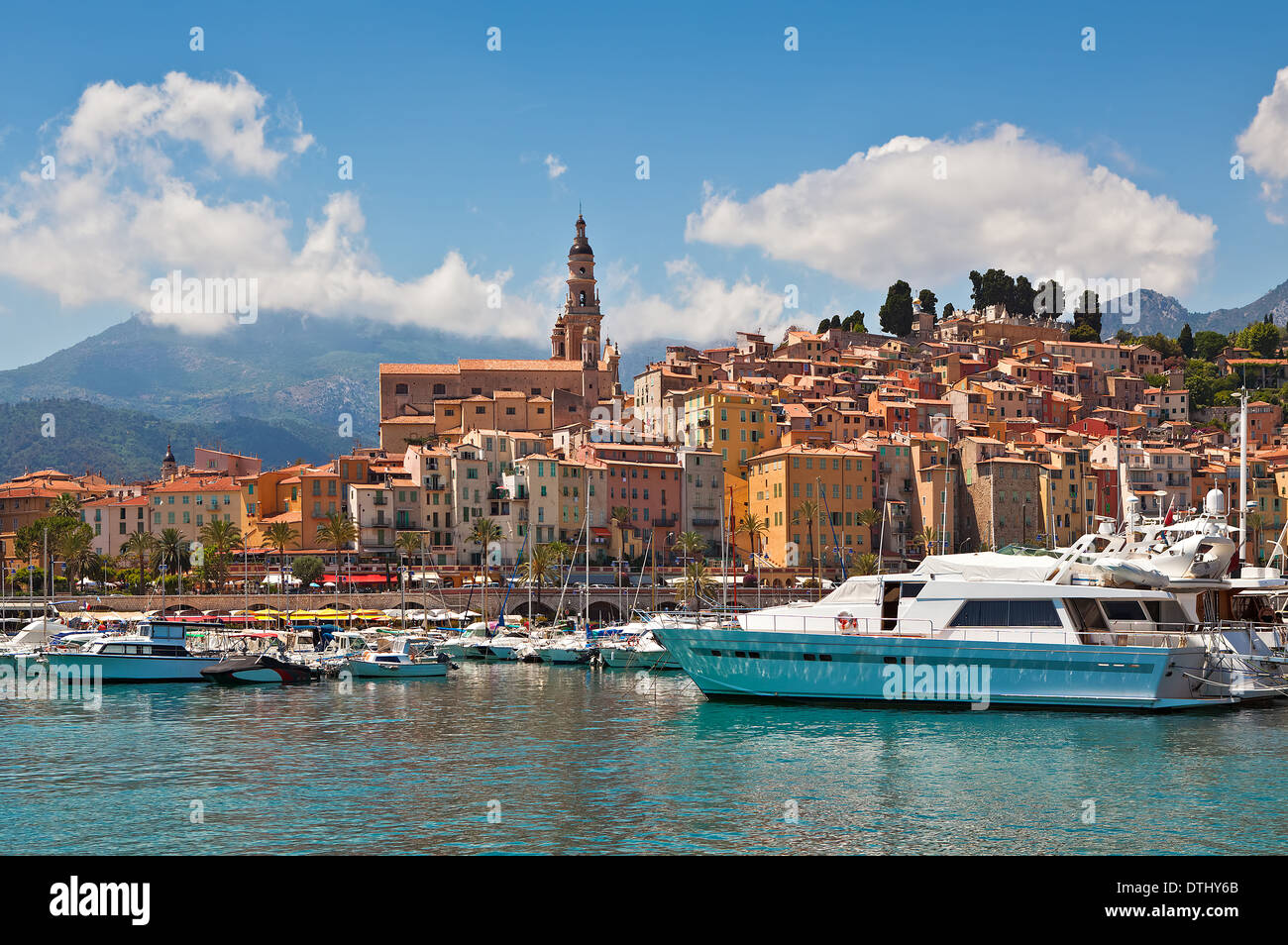 Colorful houses of old medieval town and small harbor with yachts and boats in Menton, France. Stock Photo