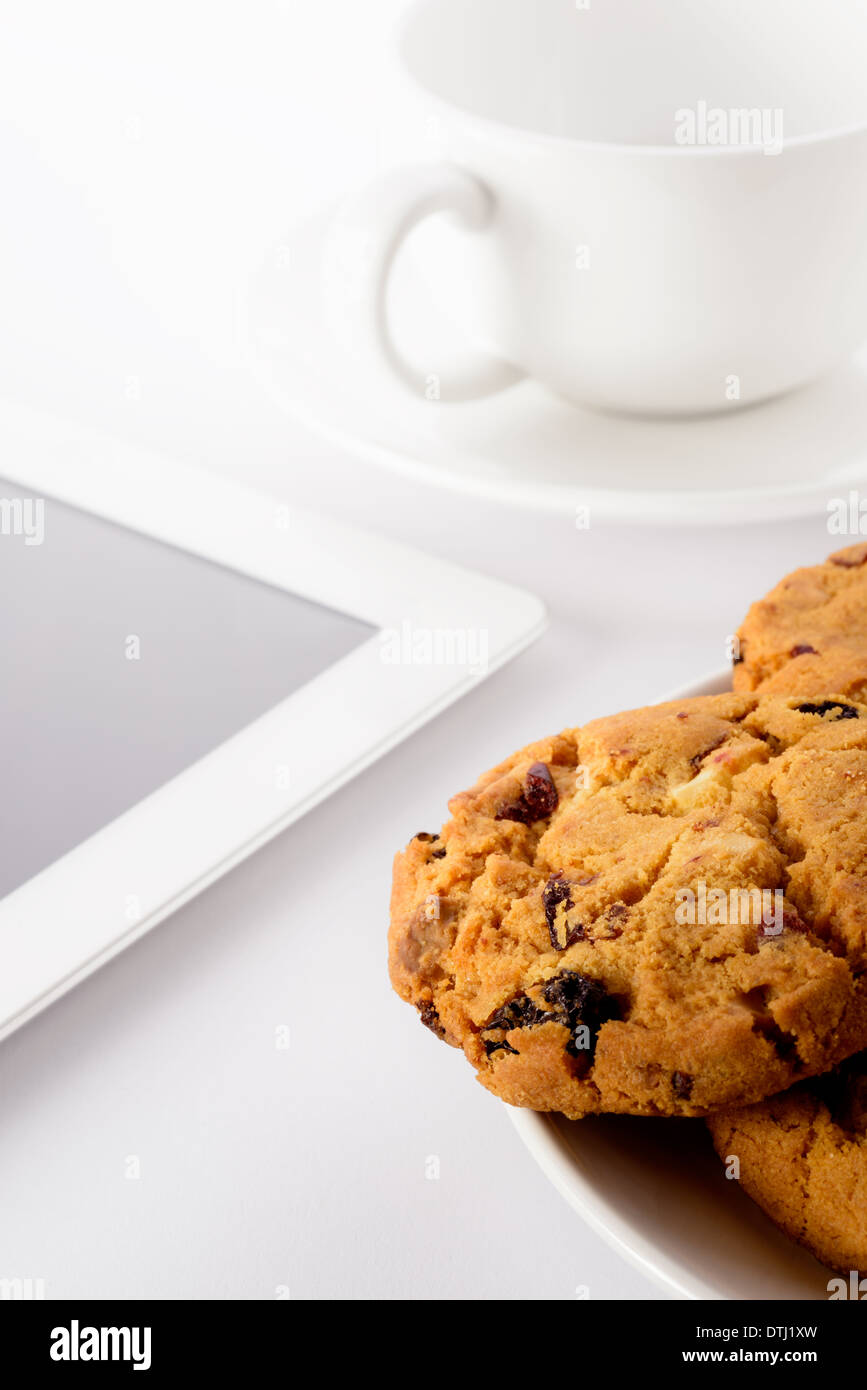 Food: fresh homemade cookies, teacup and tablet, on white background Stock Photo