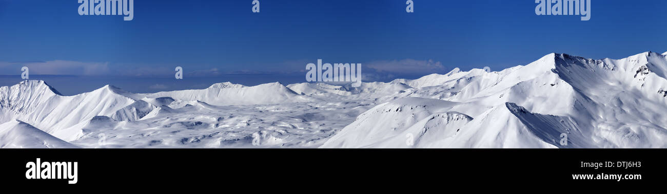 Panoramic view on snowy plateau and slopes for freeriding at nice day. Caucasus Mountains, Georgia, ski resort Gudauri. Stock Photo