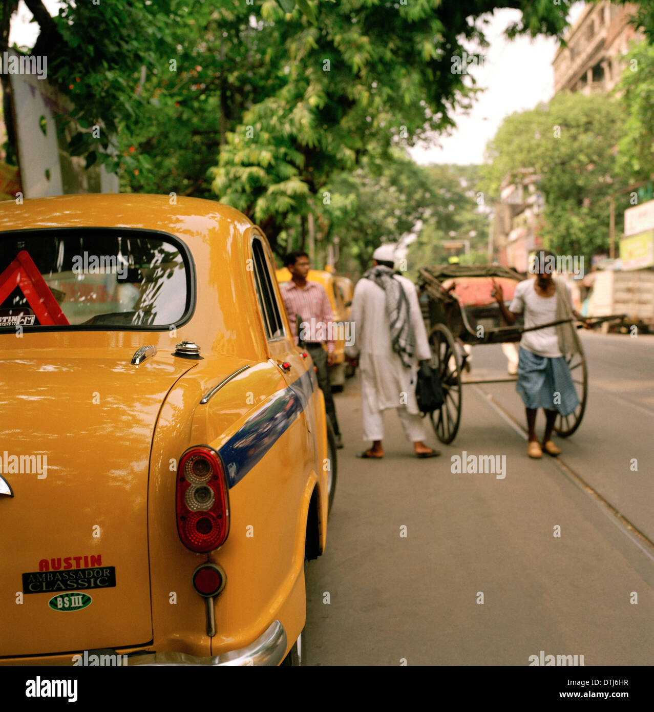 Travel Photography - Street scene in Calcutta Kolkata in West Bengal in India South Asia. People Reportage Photojournalism Yellow Taxi Lifestyle Stock Photo