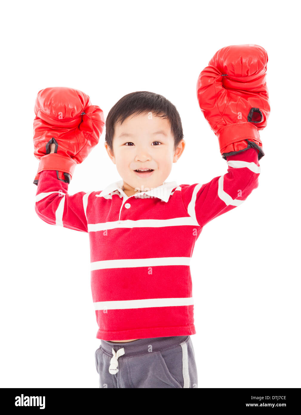 happy young kid with boxing glove in winning pose in studio Stock Photo
