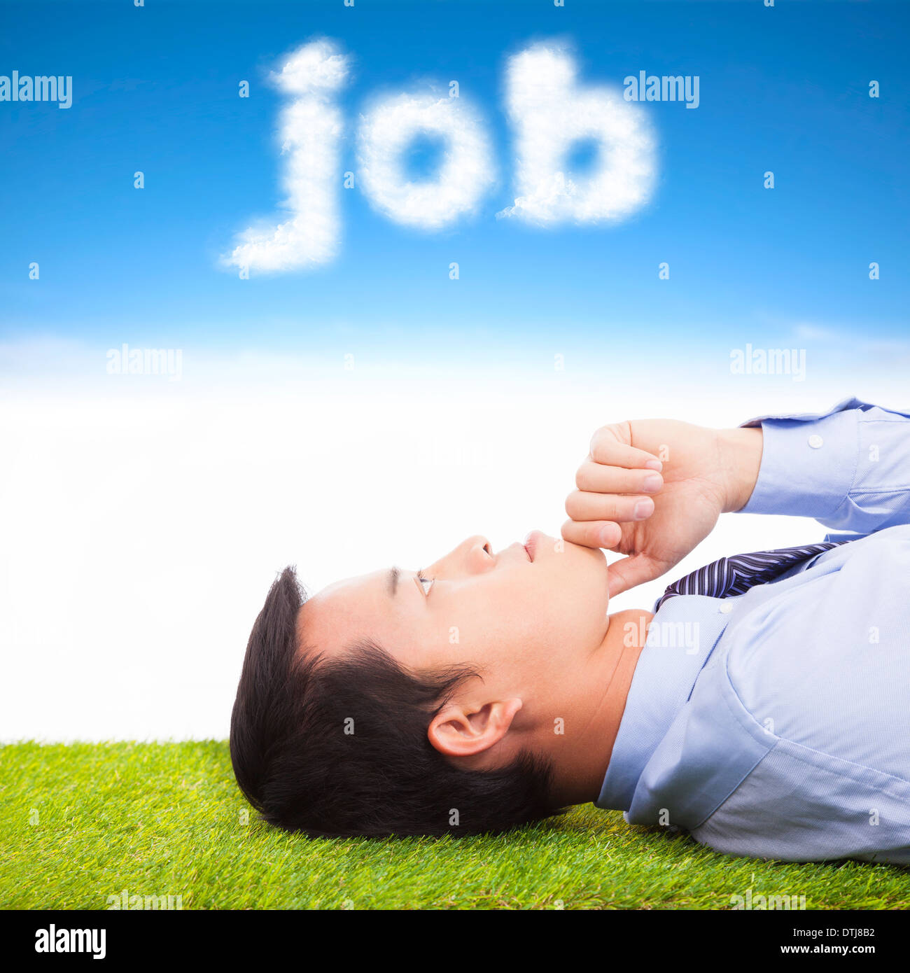 young businessman thinking  on a meadow and cloud shape Stock Photo