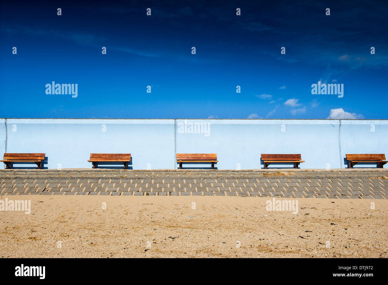 Memorial benches on the walkway of the sea wall at Canvey Island in Essex, UK. Stock Photo
