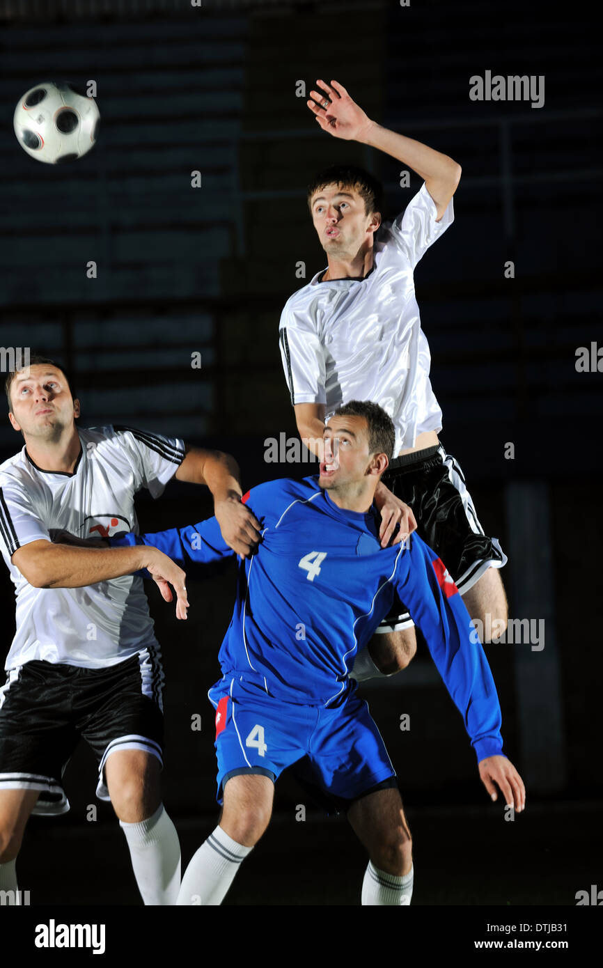 football players in action for the ball Stock Photo - Alamy