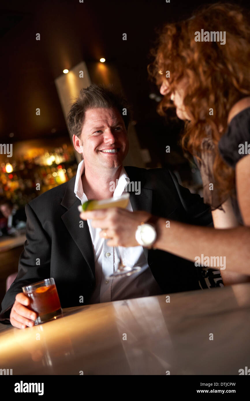 A COUPLE ENJOYING A DRINK IN A WINE BAR Stock Photo