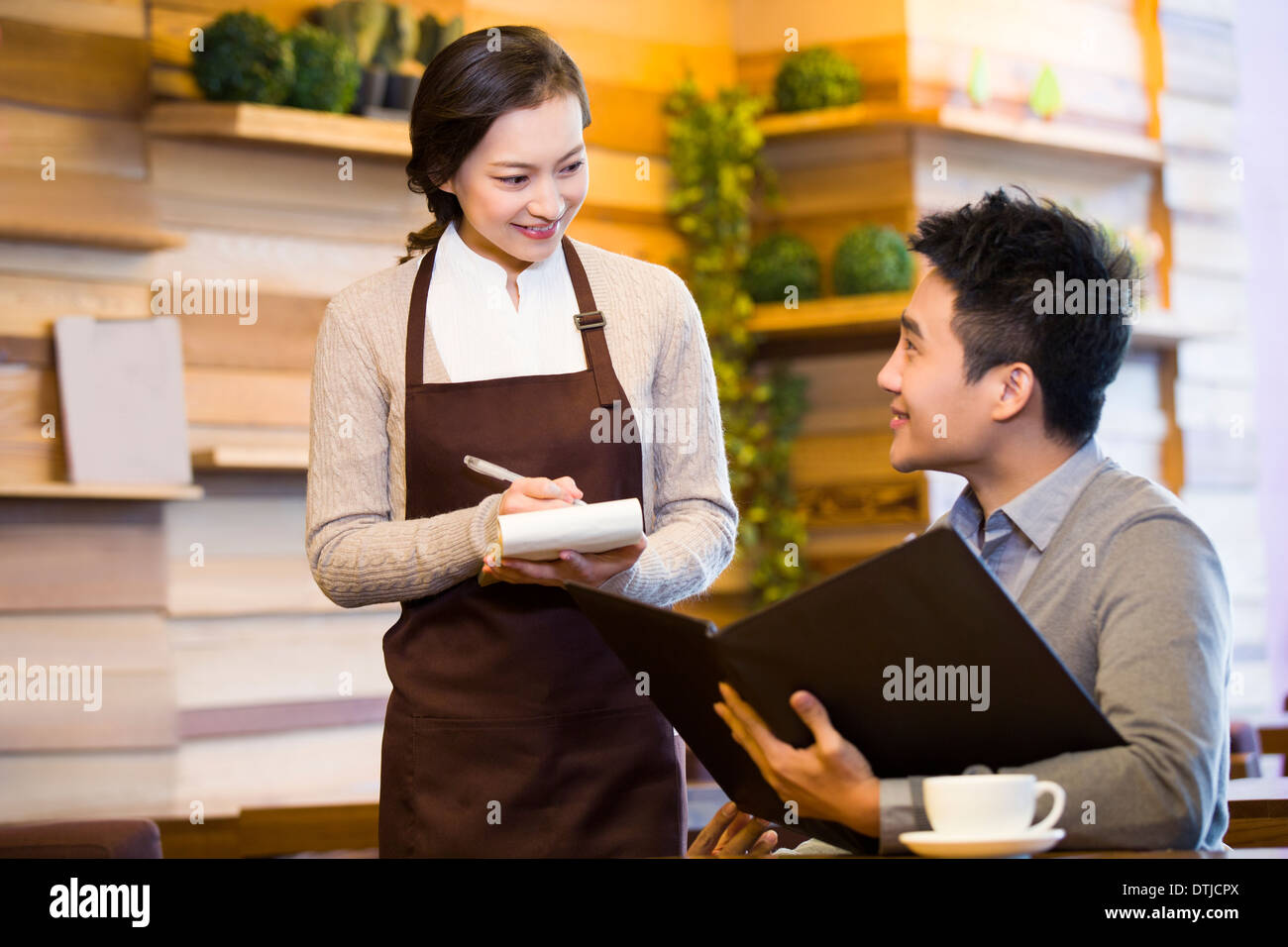 Young man ordering in coffee shop Stock Photo Alamy