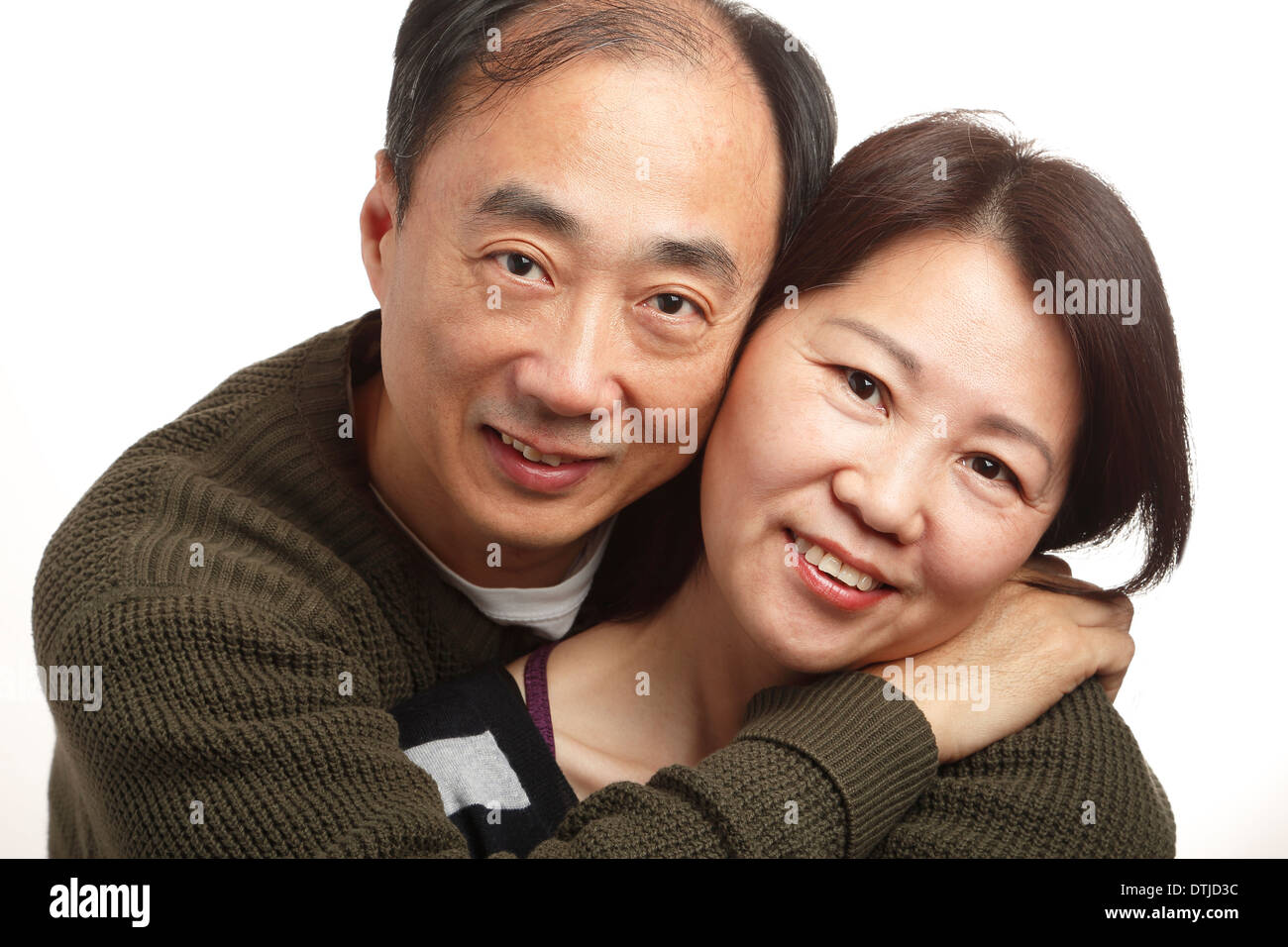 Asian middle age couple together on white background Stock Photo - Alamy