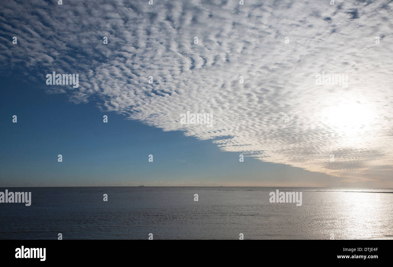 A mackerel sky or buttermilk sky of altocumulus clouds over Shingle Street, Suffolk, England Stock Photo