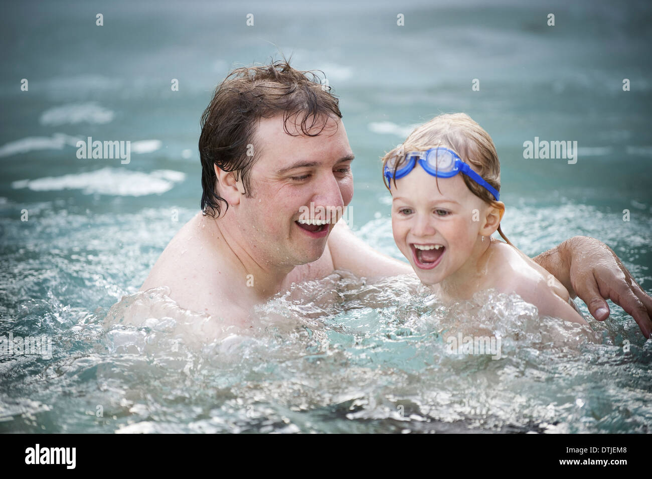 A father and son in a swimming pool swimming England Stock Photo - Alamy