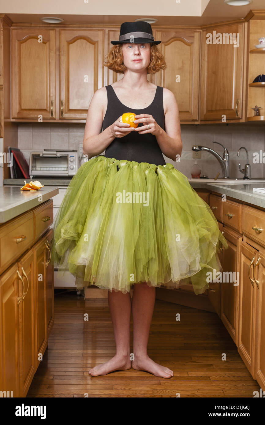 A woman wearing a lime green ballet tutu standing in a ballet position in  her kitchen Pennsylvania USA Stock Photo - Alamy