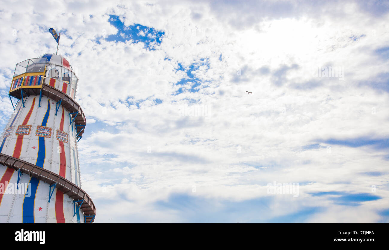 A helter skelter against a cloudy blue sky Stock Photo