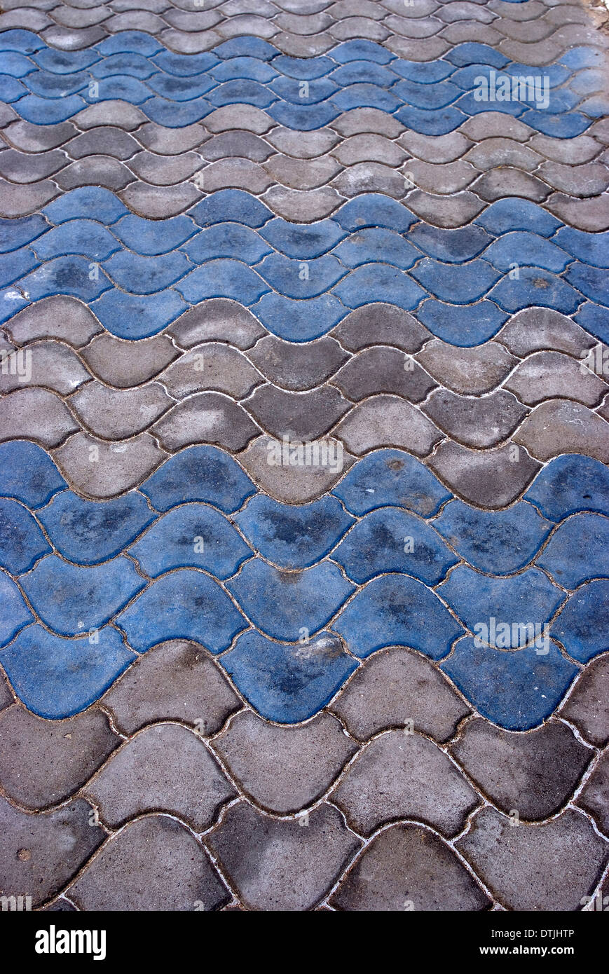 Blue and white scalloped paving stones on the corniche next to the beach, Atlantic Ocean, Essaouira, Morocco Stock Photo