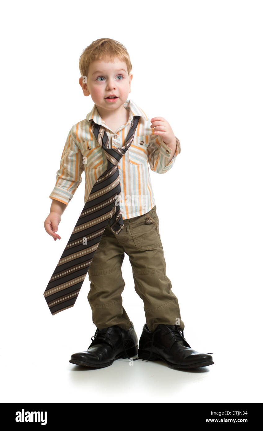 boy playing with big father's shoes isolated Stock Photo