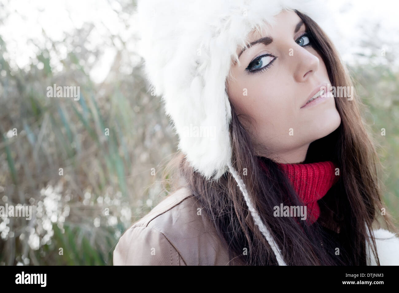 Happy brunette is having a nice time in the park while it's autumn Stock Photo