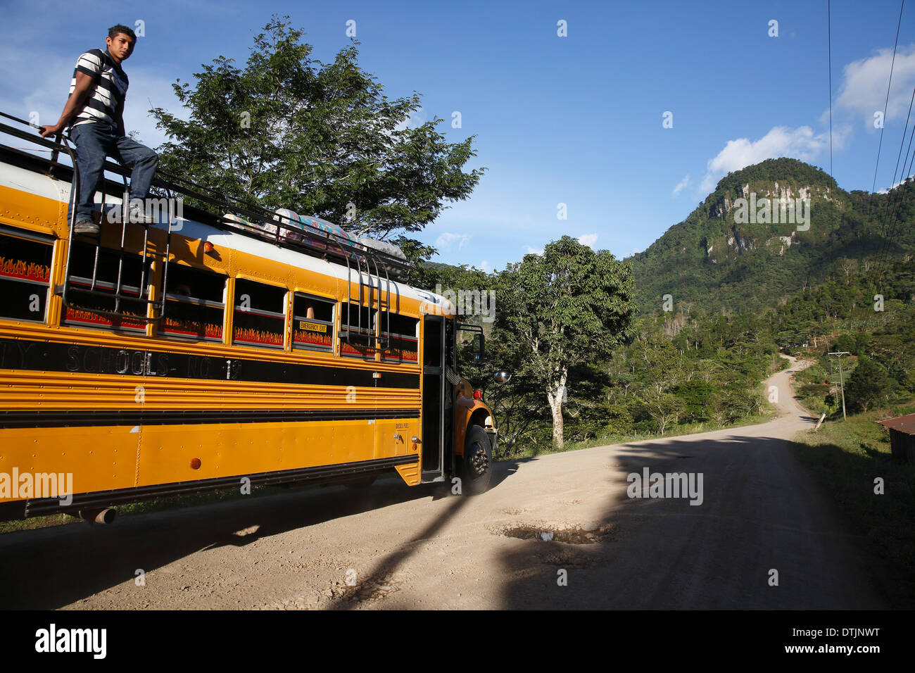 Yellow school bus used as local transport on the road in Penas Blancas, Nicaragua Stock Photo