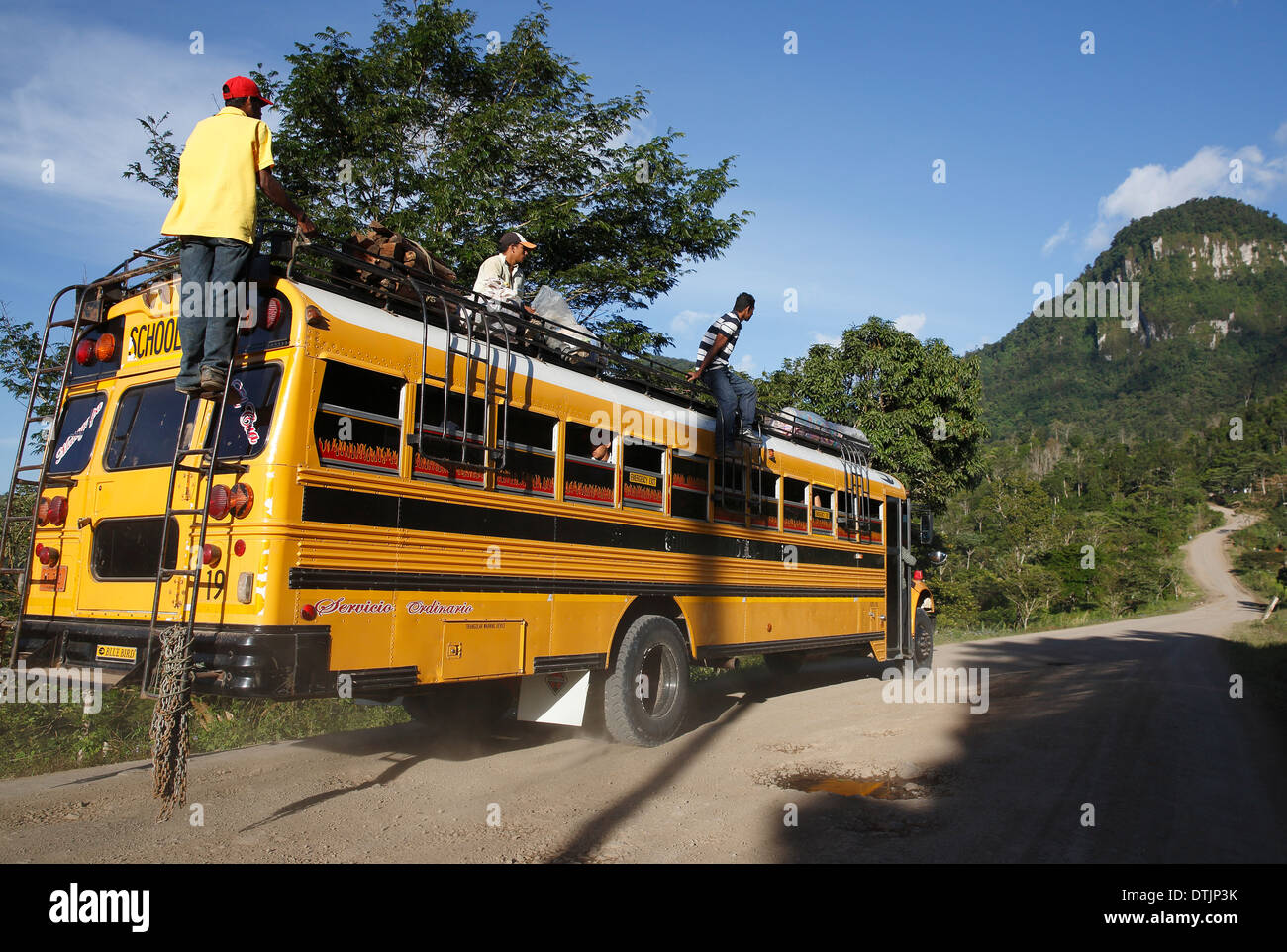 Yellow school bus used as local transport on the road in Penas Blancas, Nicaragua Stock Photo