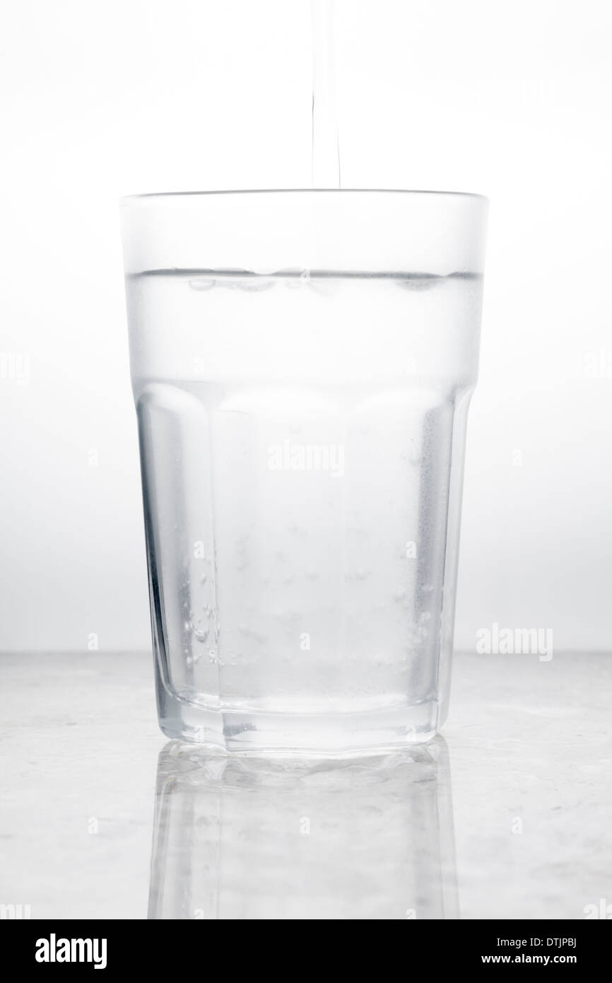 Glass of water with pour Stock Photo