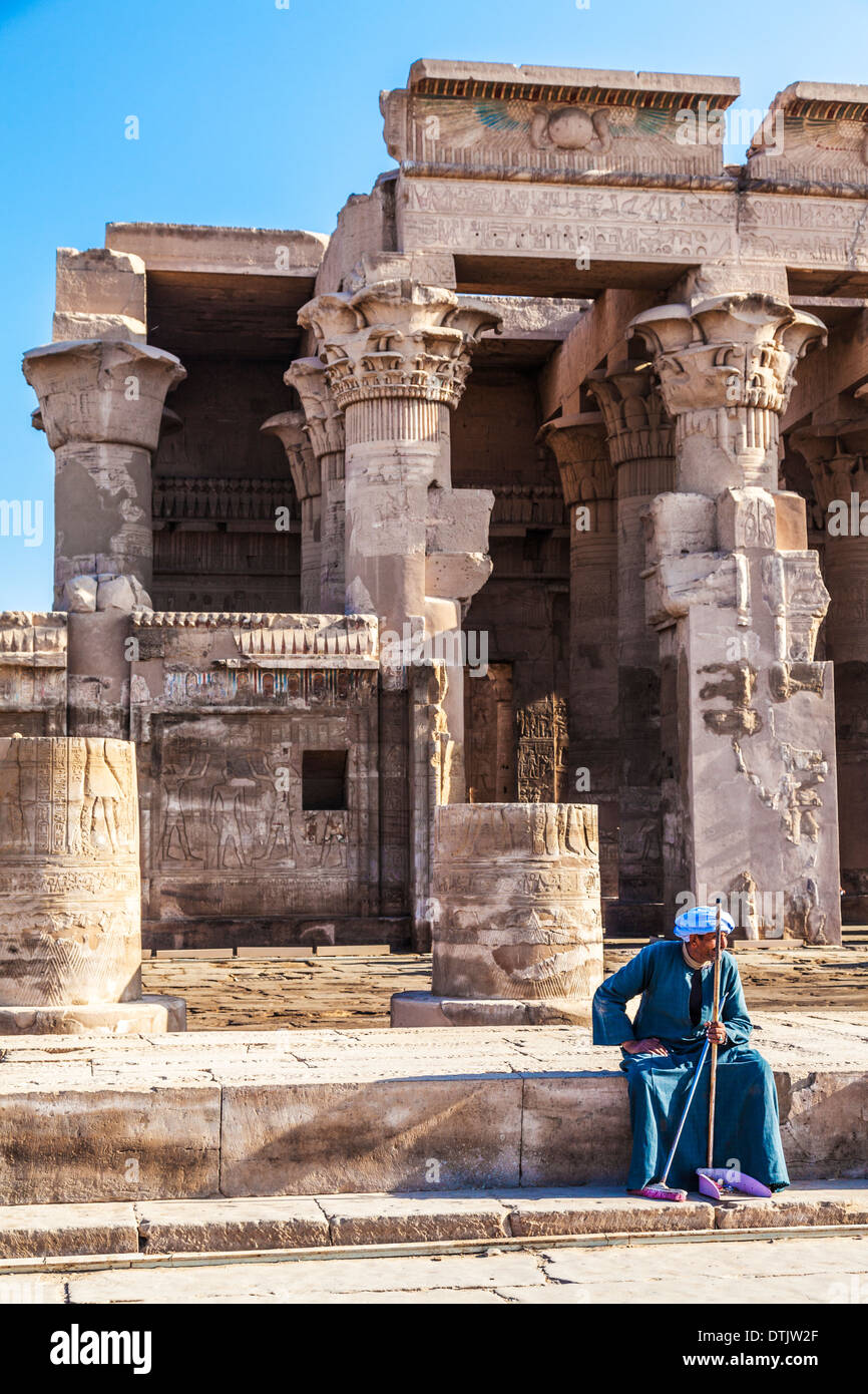 An Egyptian sweeper rests at the Ancient Egyptian Temple at Kom Ombo. Stock Photo