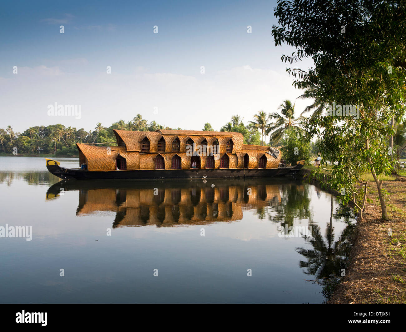 India, Kerala, backwaters, Kettuvallam boat trip houseboat reflected in backwater Stock Photo